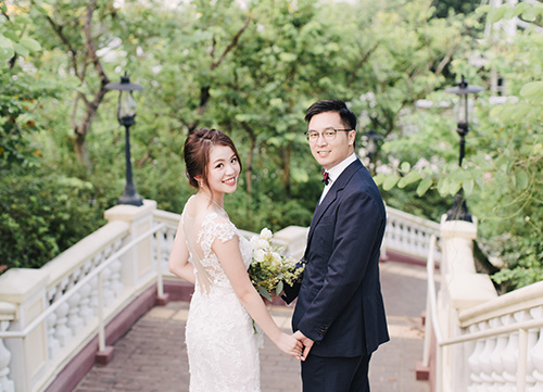 bride and groom smile at camera in central hong kong