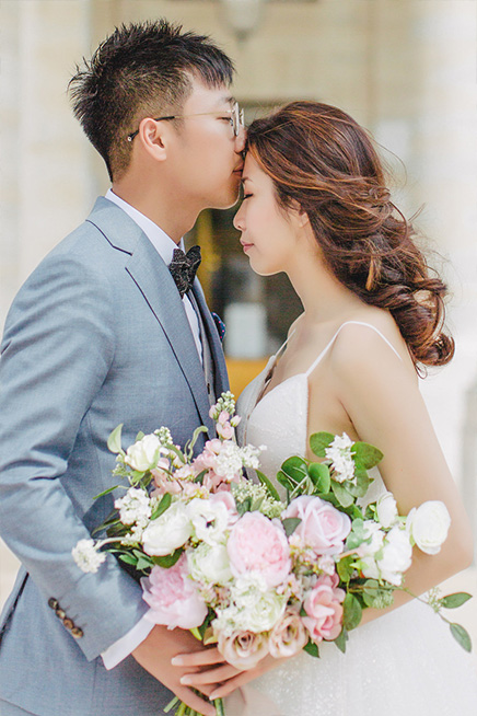 couple kissing in wedding attire