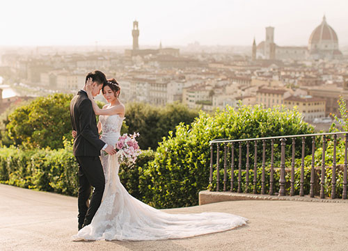 couple pose during pre wedding shoot with florence skyline in background