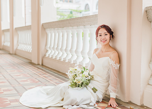 bride sits on floor against wall