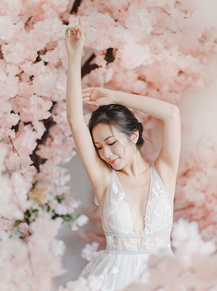 bride poses next to flowers
