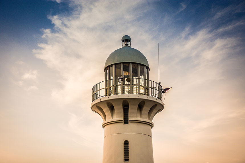photo of raffles lighthouse in singapore with cloudy blue sky